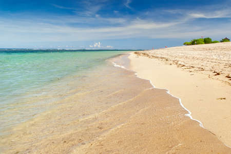 Transparent water over golden sand beach, Bali, Indonesiaの写真素材