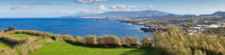 Panoramic view to the green field, town and mountains at the Atlantic ocean coast, San Miguel, Azores, Portugalの写真素材