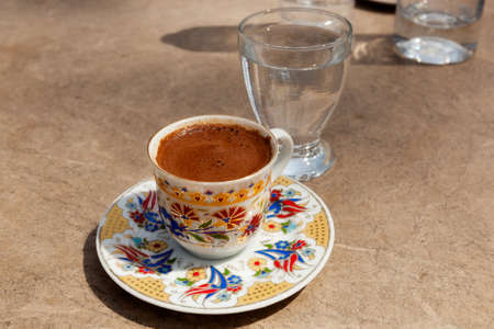 Trditionally served turkish coffee at the street cafe under light sun, Istanbul, Turkeyの写真素材