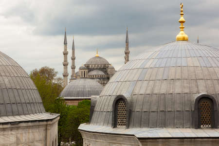 View to the Blue Mosque from Hagia Sophia under heavy clouds, Istanbul, Turkeyの写真素材