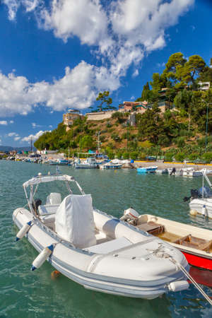 Rubberl fisherman white boat under bright sunlight, Kerkyra, Corfu, Greeceの写真素材