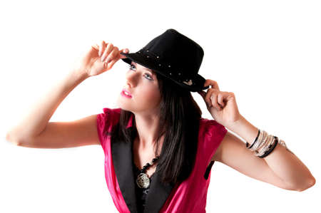 Beautiful sexy brunette model with blue eyes in sexy pink jacket and black hat standingの写真素材
