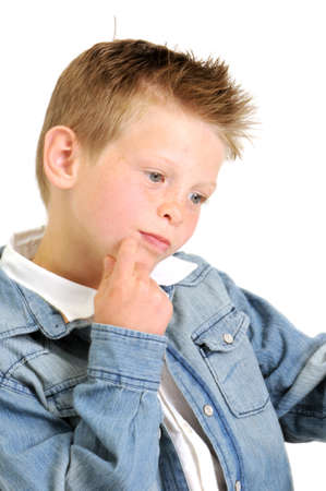 young attractive boy wearing a blue jean jacket and smilingの写真素材
