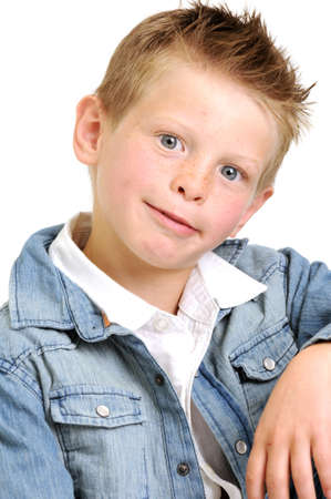young attractive boy wearing a blue jean jacket and looking goofy smilingの写真素材