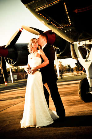 sexy young adult wedding couple standing with old war Albatross aircraftの写真素材