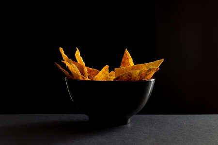 Fried spicy lavash chips in black tureenの写真素材