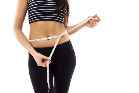 Slim girl with centimeter measuring tape isolated on white