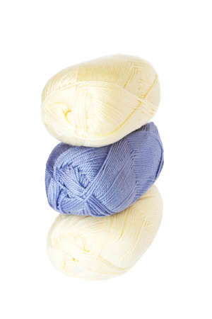 Light blue and cream coloured balls of acrylic thread isolated on whiteの写真素材