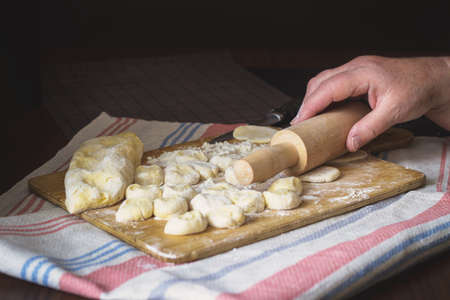 Old woman's hands cooking Ukrainian traditional dumplings with cottage cheeseの写真素材