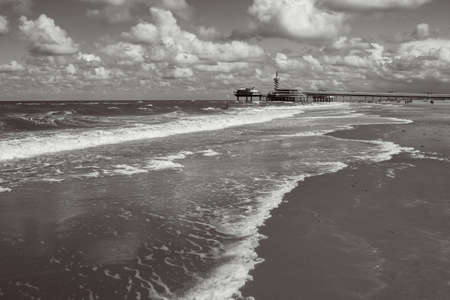 Picturesque landscape seaside scene with lighthouse building on the horizon. Hague, Scheveningen district, the Netherlandsの写真素材