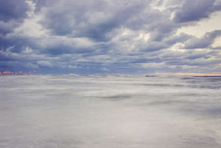 Beautiful landscape with dramatic sky above the choppy sea in the eveningの写真素材