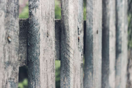 Close up of old grey wooden picket fence panels. Vintage wood background. Selective focusの写真素材