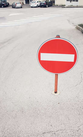 Round red sign No Entry on the street of the european city, private houses and car parking on the backgroundの写真素材
