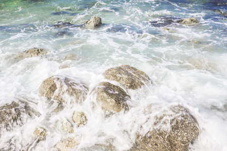Waves on rocks in sunny day, Portonovo, Italyの写真素材