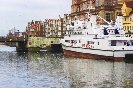 GDANSK, POLAND - JANUARY 1, 2015: View over the river with cruise ship on Motlawa river, the Old Town in Gdansk, the main seaport in Poland and is popular destination for touristsのeditorial素材