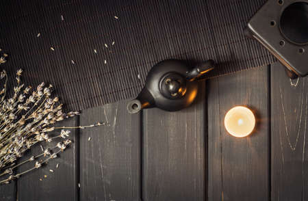 Candle driven aroma lamp diffuse essential oils for Aromatherapy or Esoterics. Dark background, Black on black colorsの写真素材