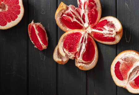 Fresh grapefruits on dark wooden background. Top view, space for textの写真素材
