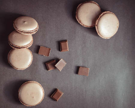 Top view of Chocolate pastel brown Macarons or Macaroons over dark backgroundの写真素材