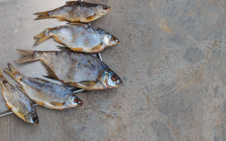 Taranka, Sun Dried Salty River Fish, Classic Beer Snack in Post Soviet Countries. Top view, grey concrete backgroundの写真素材