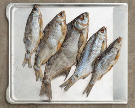 Taranka, Sun Dried Salty River Fish, Classic Beer Snack in Post Soviet Countries. Top view, grey concrete backgroundの写真素材