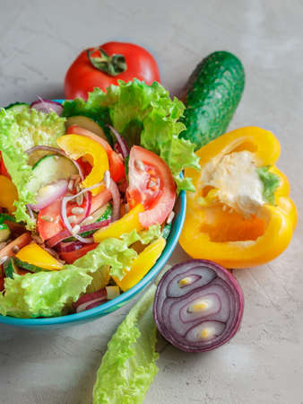 Fresh Summer Vegetable Salad in blue bowlの写真素材