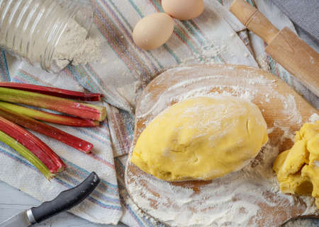 Prepared dough for rhubarb pie with ingredients on the table. Top viewの写真素材