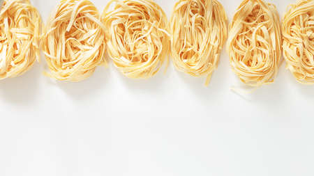 Italian Fettuccine nest pasta on light grey backgroundの写真素材
