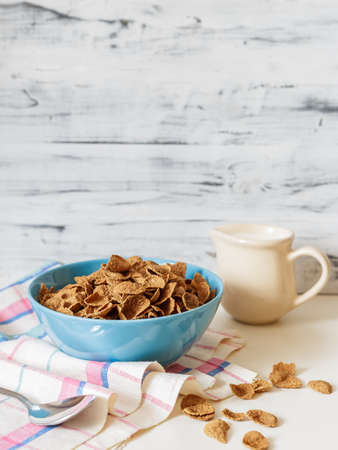 Healthy breakfast with wheat buckwheat bran cereal with milk in blue ceramic bowl. Ready to eatの写真素材