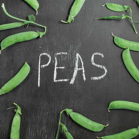 Green peas on black chalk board, the word peas written on blackboardの写真素材