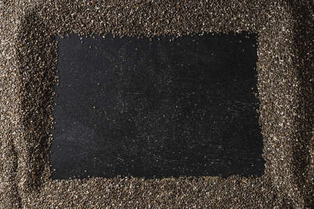 Frame of healthy organic chia seeds rich in omega-3 fatty acids over dark backgroundの写真素材