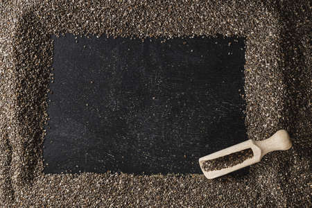 Frame of healthy organic chia seeds rich in omega-3 fatty acids over dark backgroundの写真素材