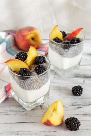 Chia seed pudding with yogurt, peach and blackberries. Healthy breakfast or morning snack conceptの写真素材