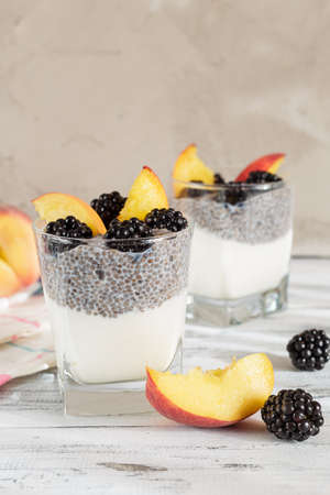 Chia seed pudding with yogurt, peach and blackberries. Healthy breakfast or morning snack conceptの写真素材