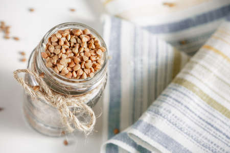 Uncooked buckwheat in glass jar. Close upの写真素材