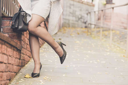 Close up of slim woman legs wearing high heel shoes on the street of old town. Female fashion conceptの写真素材