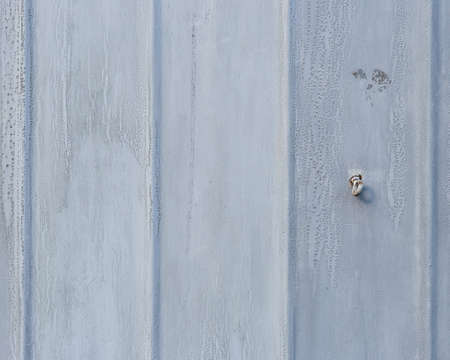 Old metal door background. Rust surface covered with grey paint