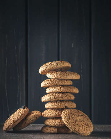Stack of oat cookies over dark wooden background
