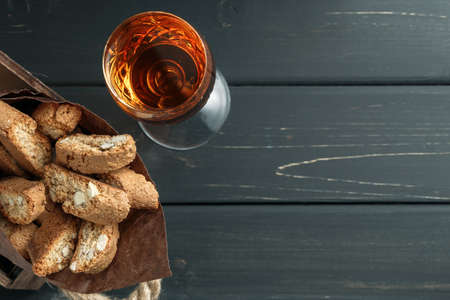 Italian cantuccini biscuits and a glass of sweet Vin Santo wine over wooden backgroundの写真素材