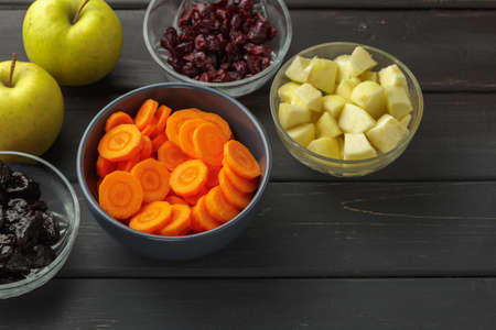 Tzimmes ingredients: carrot, apples, dried prunes and cranberries. Tsimmes is a traditional Ashkenazi Jewish sweet stewの写真素材