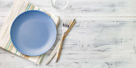 Empty purple plate on light wooden background