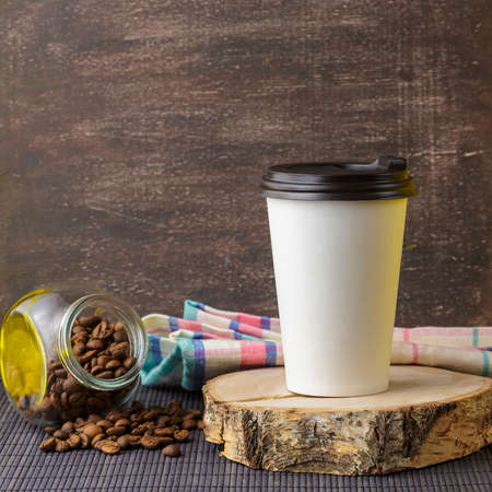 Take away coffee drink in disposable paper cup over rustic wooden backgroundの写真素材
