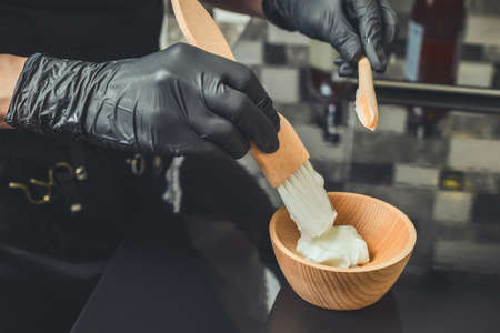 Hairdresser preparing a hair mask for treatment procedure in beauty salonの写真素材