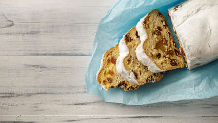 Stollen, traditional German Christmas yeast cake with raisins on the table, top view, copy spaceの写真素材