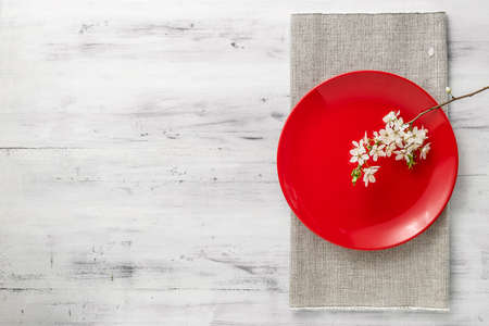 Spring table set with plates and blooming white flowers branch. top view with copy spaceの写真素材