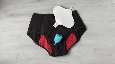 Reusable eco-friendly feminine hygiene period products - menstrual cup and black menstruation pants...