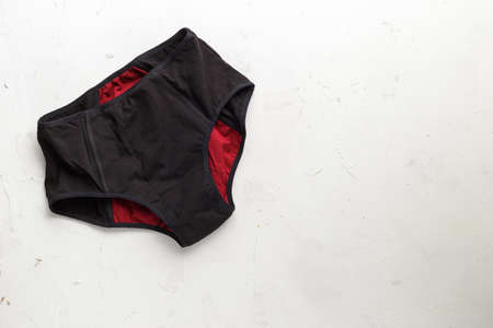 Reusable eco-friendly feminine hygiene period menstruation underwear pants. Top view on white textured background.の写真素材