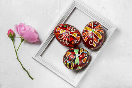 Pysanky, Ukrainian Easter eggs decorated with wax-resist dyeing technique on white wooden backgroundの写真素材