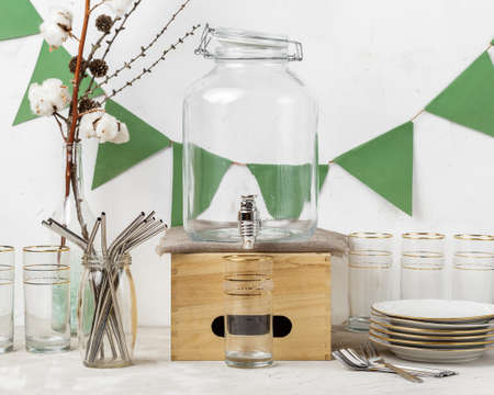 Reusable straws, drinking glass and plates prepared for eco friendly zero waste party with no...