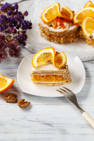 A Piece of Orange Cake on a Square Dish with Fork ready to eatの写真素材