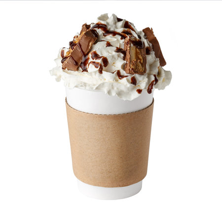 Coffee drink covered with whipped cream, chocolate syrup and candies in paper cup to go isolated on white backgroundの写真素材